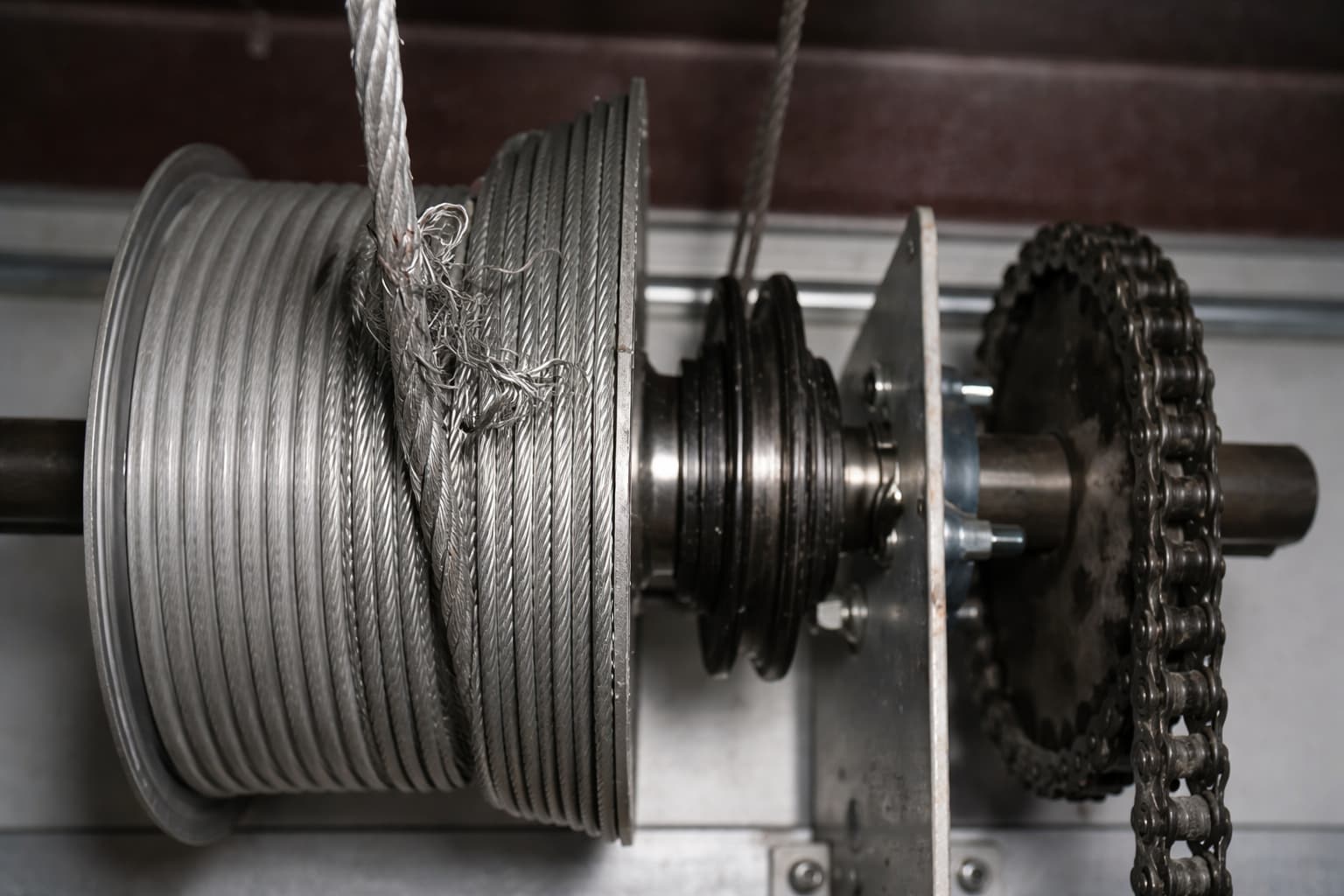Worn garage door spring and cable that need replacement